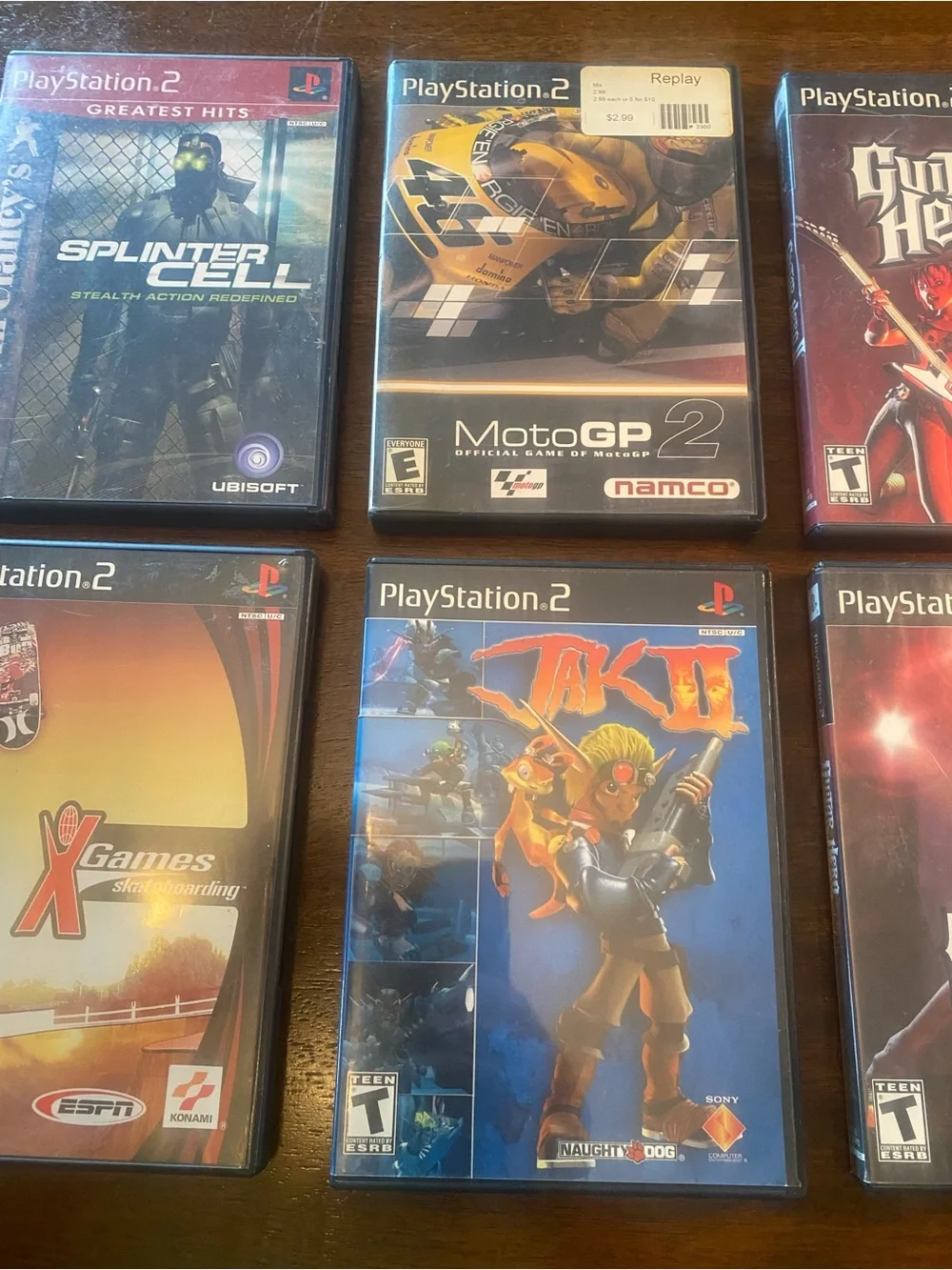 6 PS2 Jak II, Guitar Hero I & II, Splinter Cell, MotoGP 2, X Games Skateboarding